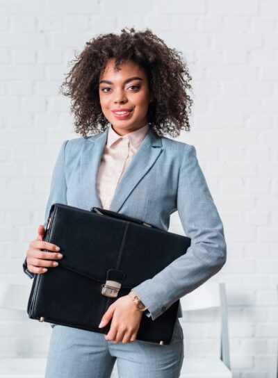 African american businesswoman in suit holding briefcase